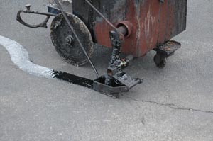Hot pour asphalt driveway crack filling closeup picture